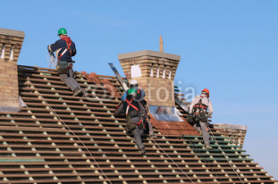 Man_working_on_the_new_roof.jpg